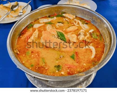 a bowl of soup with shrimp and shrimp.