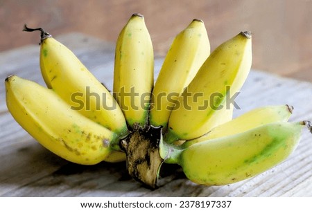 a bunch of bananas on a wooden table.