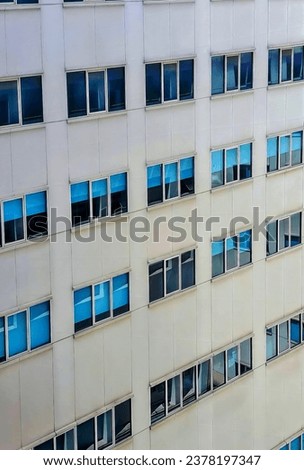 blue windows in a white building.