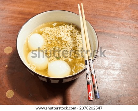 Noodle Instant In a ceramic cup and a boiled egg It's food for a quick meal.