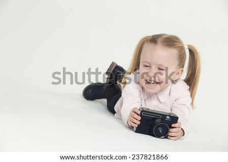 Smiling and having fun the photographer a beautiful blond girl on white background