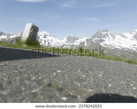 Riga, Latvia - AUGUST 20 2023.  a view of a mountain range from a road with a stop sign in the foreground. . 