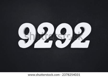 Black for the background. The number 9292 is made of white painted wood.