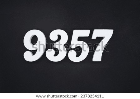 Black for the background. The number 9357 is made of white painted wood.