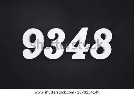 Black for the background. The number 9348 is made of white painted wood.