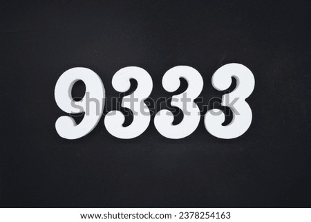 Black for the background. The number 9333 is made of white painted wood.