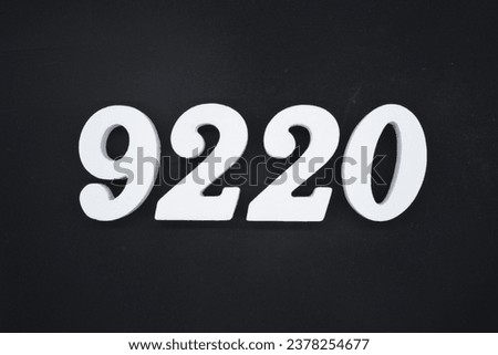 Black for the background. The number 9220 is made of white painted wood.
