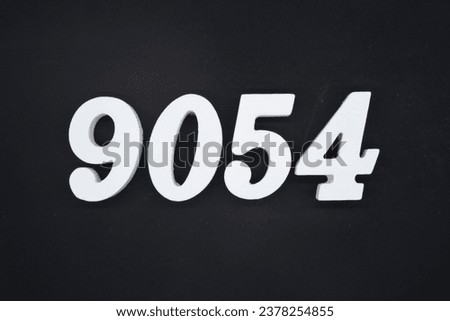 Black for the background. The number 9054 is made of white painted wood.