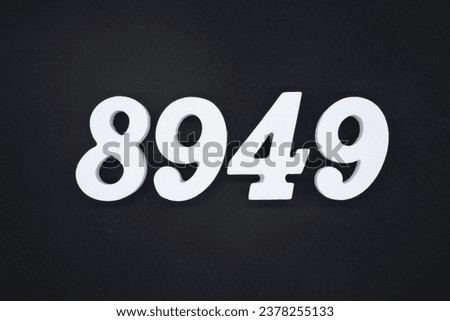 Black for the background. The number 8949 is made of white painted wood.