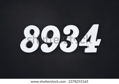Black for the background. The number 8934 is made of white painted wood.