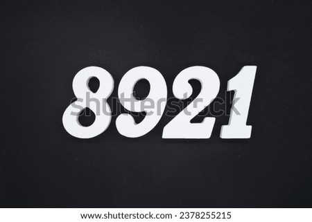 Black for the background. The number 8921 is made of white painted wood.