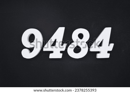 Black for the background. The number 9484 is made of white painted wood.