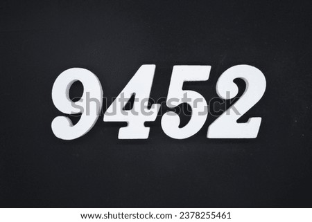 Black for the background. The number 9452 is made of white painted wood.