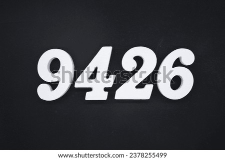 Black for the background. The number 9426 is made of white painted wood.