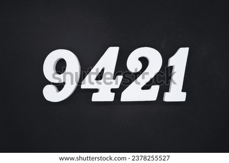 Black for the background. The number 9421 is made of white painted wood.