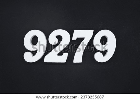 Black for the background. The number 9279 is made of white painted wood.