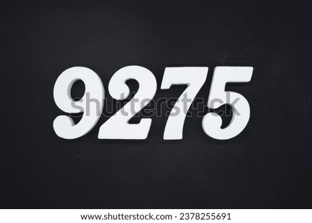 Black for the background. The number 9275 is made of white painted wood.