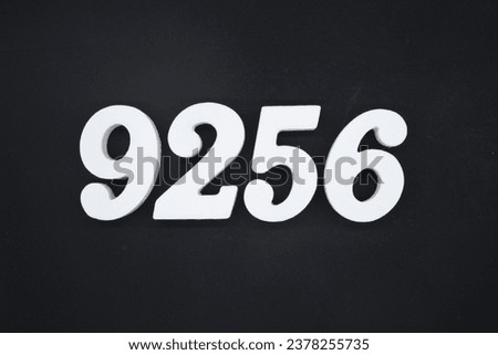 Black for the background. The number 9256 is made of white painted wood.