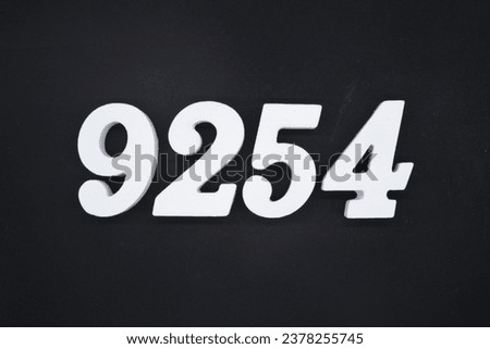 Black for the background. The number 9254 is made of white painted wood.