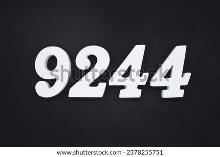 Black for the background. The number 9244 is made of white painted wood.