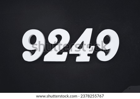 Black for the background. The number 9249 is made of white painted wood.