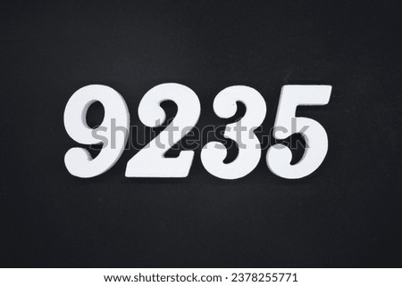 Black for the background. The number 9235 is made of white painted wood.