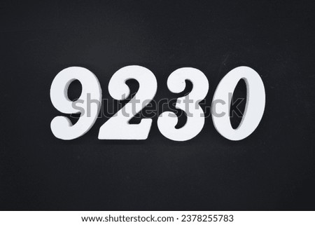 Black for the background. The number 9230 is made of white painted wood.
