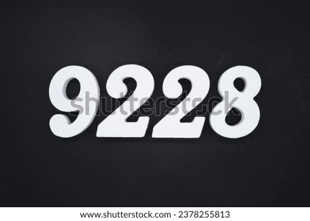 Black for the background. The number 9228 is made of white painted wood.
