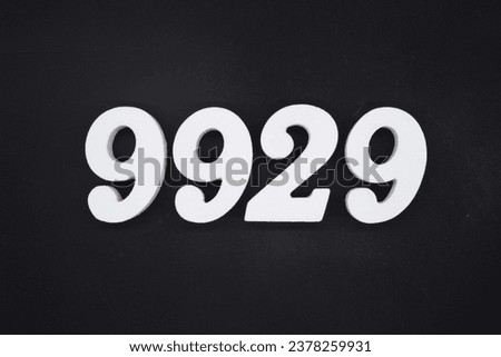 Black for the background. The number 9929 is made of white painted wood.