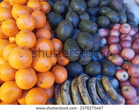 Avocados, bananas,  orange,apples nicely pictured in market 