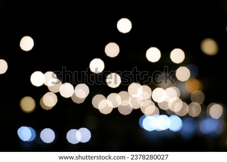Warm white, gold and silver blurred bokeh lights on black background. abstract blurred light element that can be used for cover decoration overlay background. defocused circle round lightbulbs .