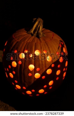 Glowing Halloween pumpkins, hand-cut patterns.