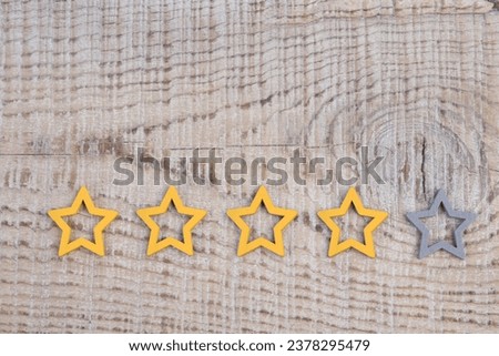 Gold, gray, silver five stars shape on wooden background. The best excellent business services rating customer experience concept. Concept image of setting a five star goal.