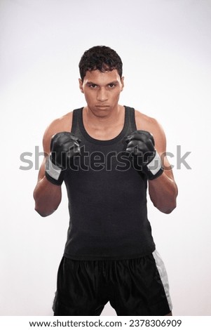 Portrait, getting ready and a man or boxer for a competition, fitness or training on a white background. Exercise, cardio and a strong male fighter with gloves for a sport, boxing or workout Royalty-Free Stock Photo #2378306909