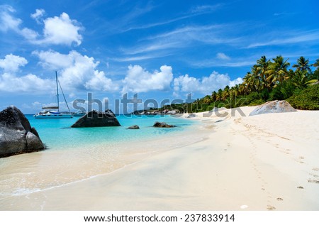 Stunning beach with white sand, unique huge granite boulders, turquoise ocean water and blue sky at Virgin Gorda, British Virgin Islands in Caribbean Royalty-Free Stock Photo #237833914
