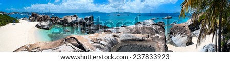 Panorama of a picture perfect beach with white sand, unique huge granite boulders, turquoise ocean water and blue sky at Virgin Gorda, British Virgin Islands in Caribbean
