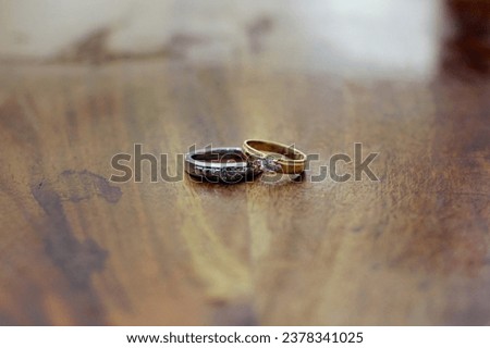 wedding rings, a special symbol of marriage on a bokeh textured wooden background

￼


