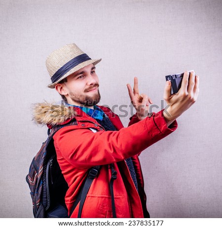 Young tourist taking a picture with camera