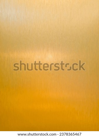 Background of golden stainless steel sheet with texture stripes as wall decoration in a room
