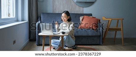 Portrait of young working woman, korean girl studying on remote online, talking to laptop, video chat, has conversation via computer application. Royalty-Free Stock Photo #2378367229