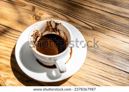 above viiew of cup of Turkish coffee with grounds and patterns left after drinking on saucer for fortune telling on wooden table in street cafe on sunny morning Royalty-Free Stock Photo #2378367987
