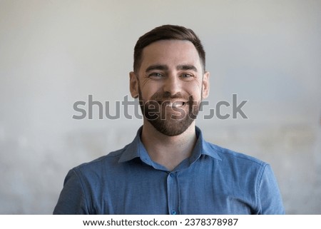 Happy handsome Caucasian man in casual blue shirt looking at camera, smiling, laughing. Cheerful millennial business professional, businessman, small company owner, leader indoor head shot portrait Royalty-Free Stock Photo #2378378987