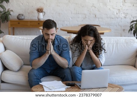 Upset concerned couple of homeowners, renters, bank customers overwhelmed with bad news, having finance loss, money troubles, getting too high mortgage, loan monthly fees Royalty-Free Stock Photo #2378379007