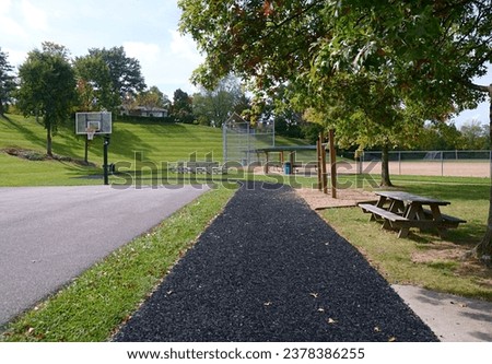 Beautiful local Park in the USA with recycled rubber walkways work out areas and baseball field walking trail outdoor photography. 