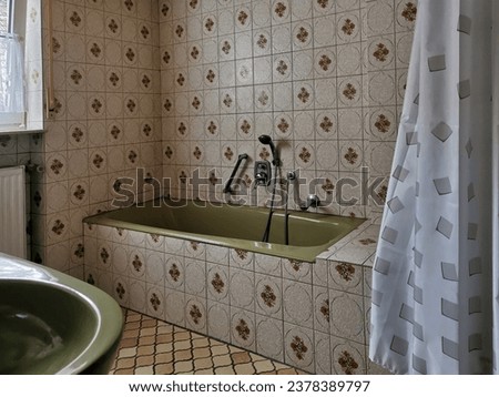 Very old bathroom with floral pattern tiles Royalty-Free Stock Photo #2378389797