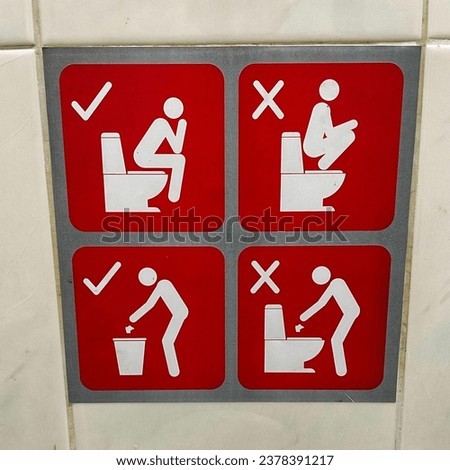 Toilet sign. Signs of how to use the toilet. Toilet sign in the toilet