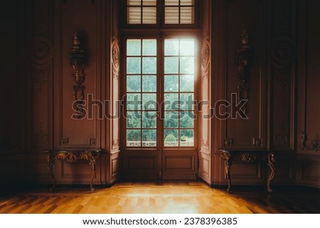 Beautiful hall in victorian style in Benrath castle, pink walls and big door with window, view on the garden.  Royalty-Free Stock Photo #2378396385