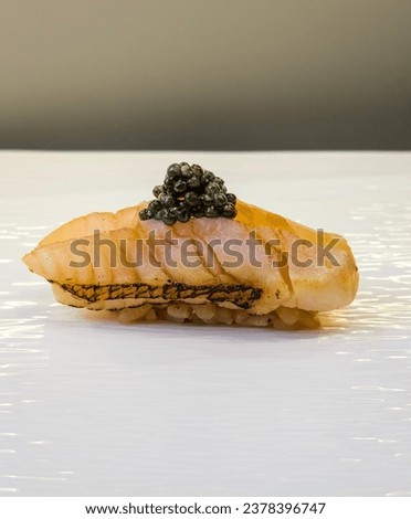 This is Madai sushi (Japanese red sea beams) on top caviar . Royalty-Free Stock Photo #2378396747