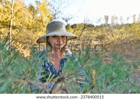 Autumn photo shoot of a beautiful woman in a pine forest.