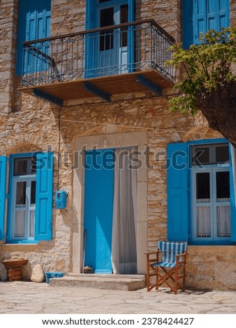 Cute details of windows, doors, balconies from old house in Simi island . Greece islands holidays from Rhodos in Aegean Sea. Colorful neoclassical houses in bay of Symi. Holiday travel background. Royalty-Free Stock Photo #2378424427